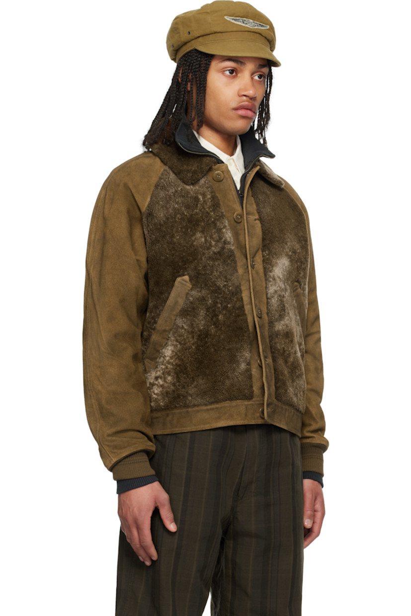 Suede and lambskin shearling jacket. 

· Paneled construction 
· Spread collar
· Button closure
· Welt pockets
· Raglan sleeves
· Rib-knit cuffs
· Inverted box pleat at yoke 
· Adjustable cinch tabs at back hem 
· Welt pocket at interior 
· Check pattern at yarn-dyed cotton flannel lining 
· Brushed chamois pocket lining 
· Corozo hardware 

Supplier color: Vintage brown