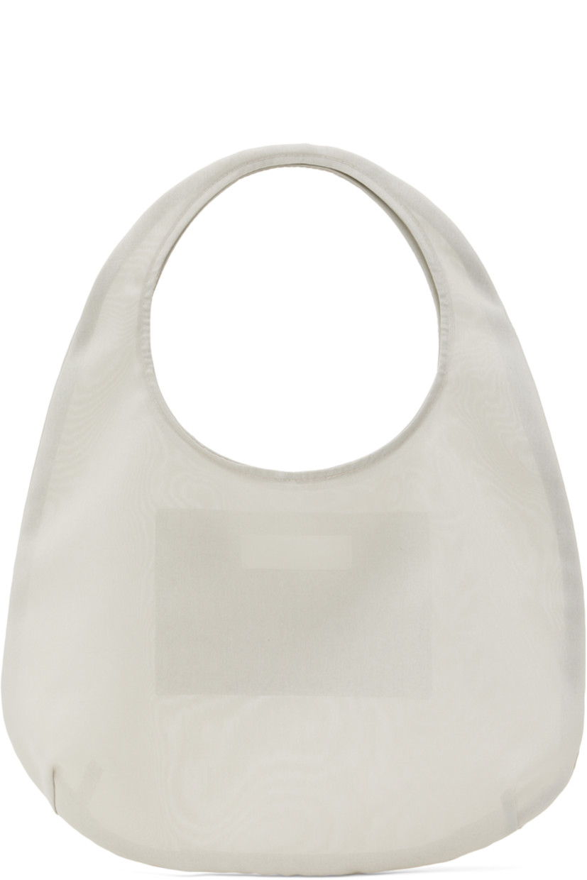 Sheer moiré tote in beige.

· Integrated carry handle
· Open throat
· Patch pocket at interior 
· H8.5" x W12" x D2.5"
· Total height: H14.5"

Supplier color: Beige