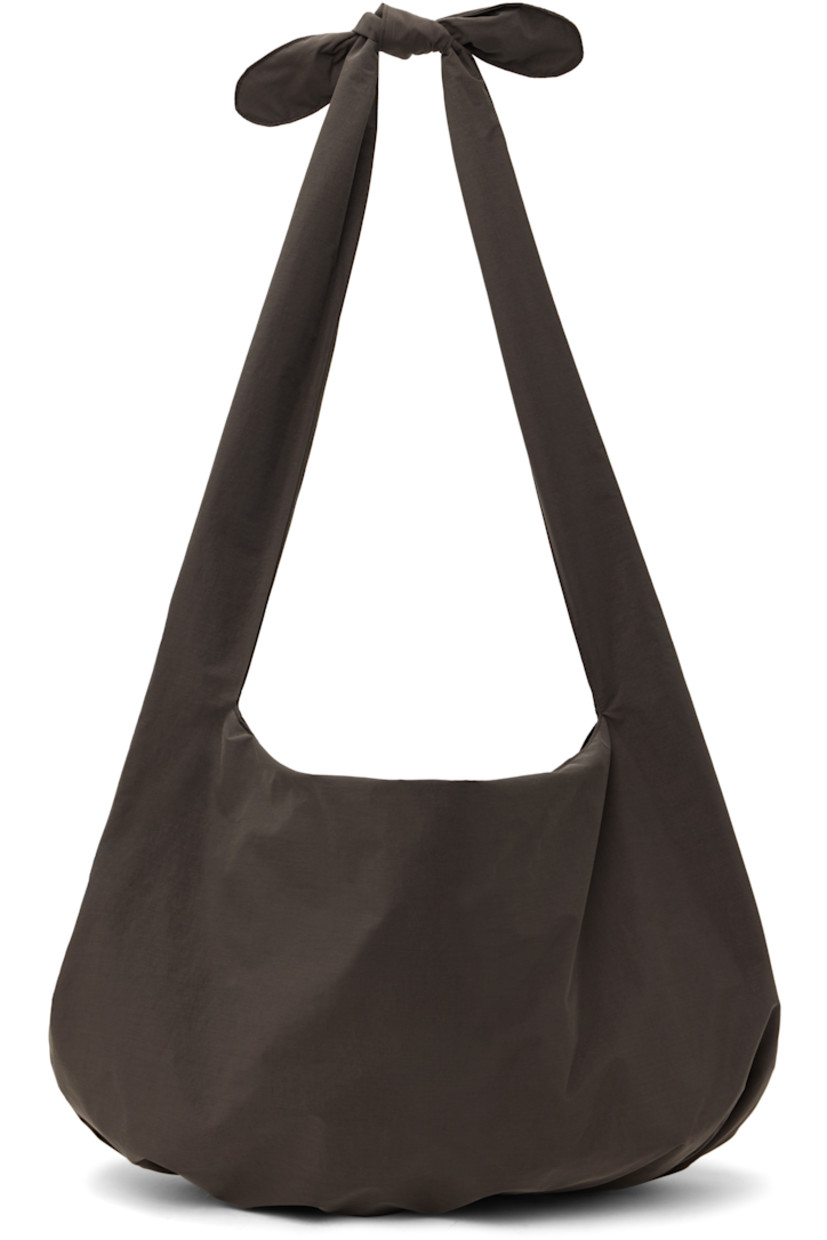 Nylon taffeta shoulder bag in brown. 

· Adjustable self-tie shoulder strap
· Gathering at base 
· Open throat
· Removable base pad at interior 
· Full plain-woven lining 
· H15" x W21" x D4"

Available exclusively at SSENSE. 

Supplier color: Brown