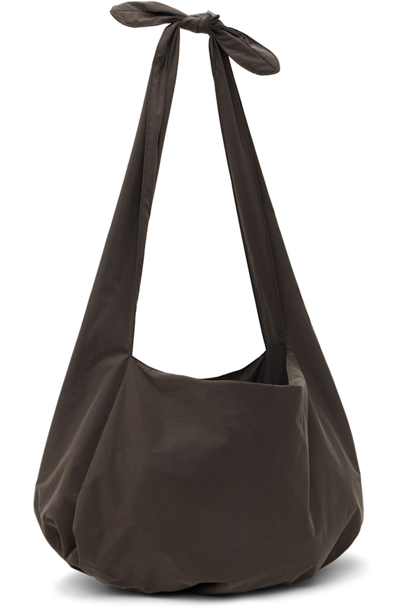 Nylon taffeta shoulder bag in brown. 

· Adjustable self-tie shoulder strap
· Gathering at base 
· Open throat
· Removable base pad at interior 
· Full plain-woven lining 
· H15" x W21" x D4"

Available exclusively at SSENSE. 

Supplier color: Brown