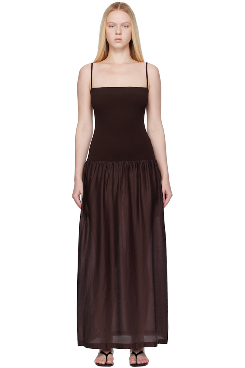 Ribbed crêpe and lightweight semi-sheer poplin maxi dress. 

· Straight neck
· Gathering at dropped waist
· Seam pockets
· Elasticized shoulder straps
· Central vent at back hem

Supplier color: Burgundy