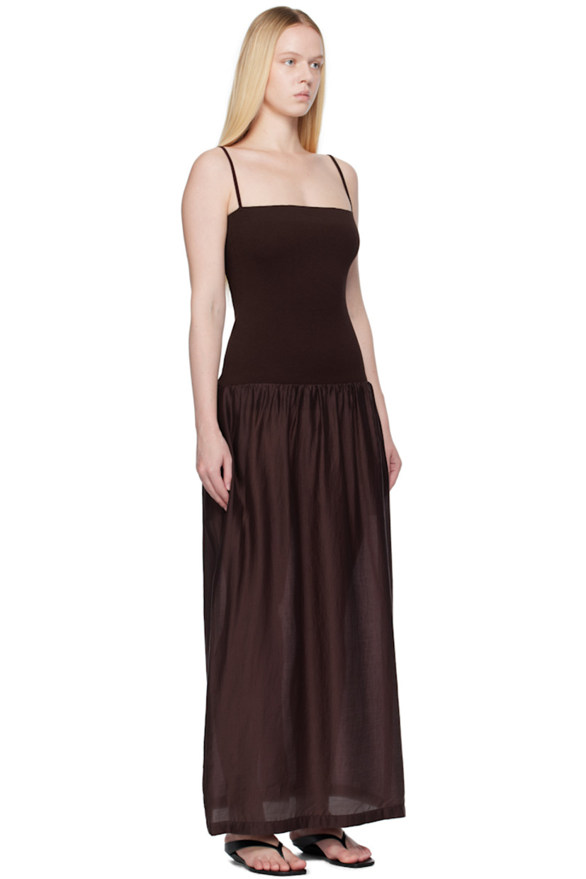 Ribbed crêpe and lightweight semi-sheer poplin maxi dress. 

· Straight neck
· Gathering at dropped waist
· Seam pockets
· Elasticized shoulder straps
· Central vent at back hem

Supplier color: Burgundy