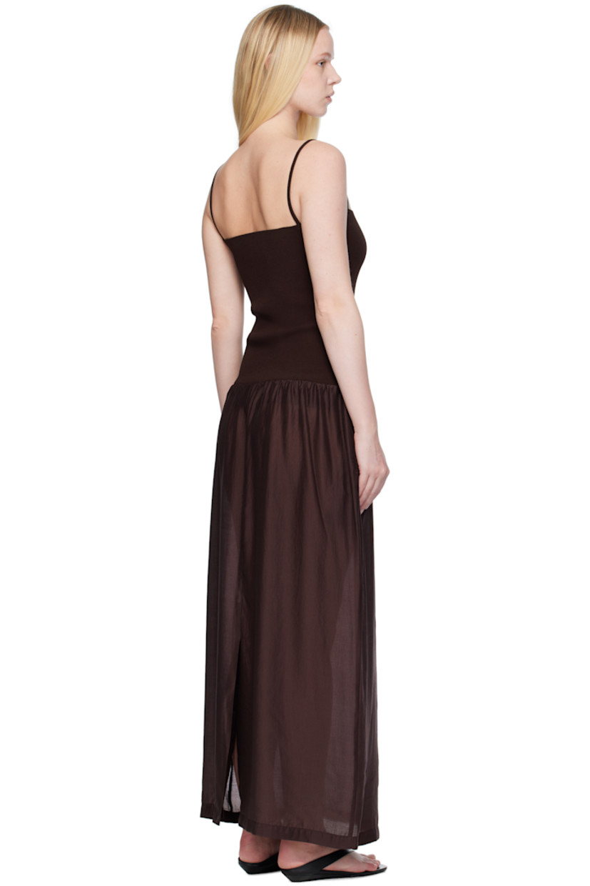 Ribbed crêpe and lightweight semi-sheer poplin maxi dress. 

· Straight neck
· Gathering at dropped waist
· Seam pockets
· Elasticized shoulder straps
· Central vent at back hem

Supplier color: Burgundy