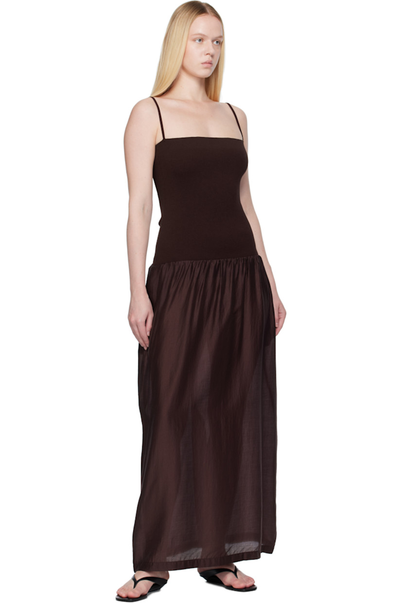 Ribbed crêpe and lightweight semi-sheer poplin maxi dress. 

· Straight neck
· Gathering at dropped waist
· Seam pockets
· Elasticized shoulder straps
· Central vent at back hem

Supplier color: Burgundy