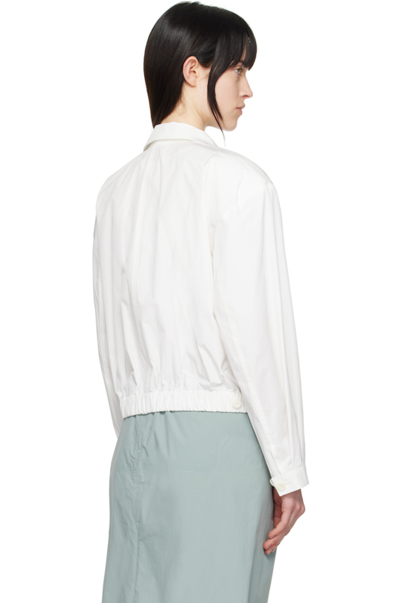 Lightweight crinkled polyester- and cotton-blend taffeta jacket.

· Button tab at spread collar
· Two-way zip closure 
· Darts at front 
· Seam pockets
· Partially elasticized cropped hem
· Adjustable button tab at cuffs
· Adjustable button tabs at back hem

Supplier color: White