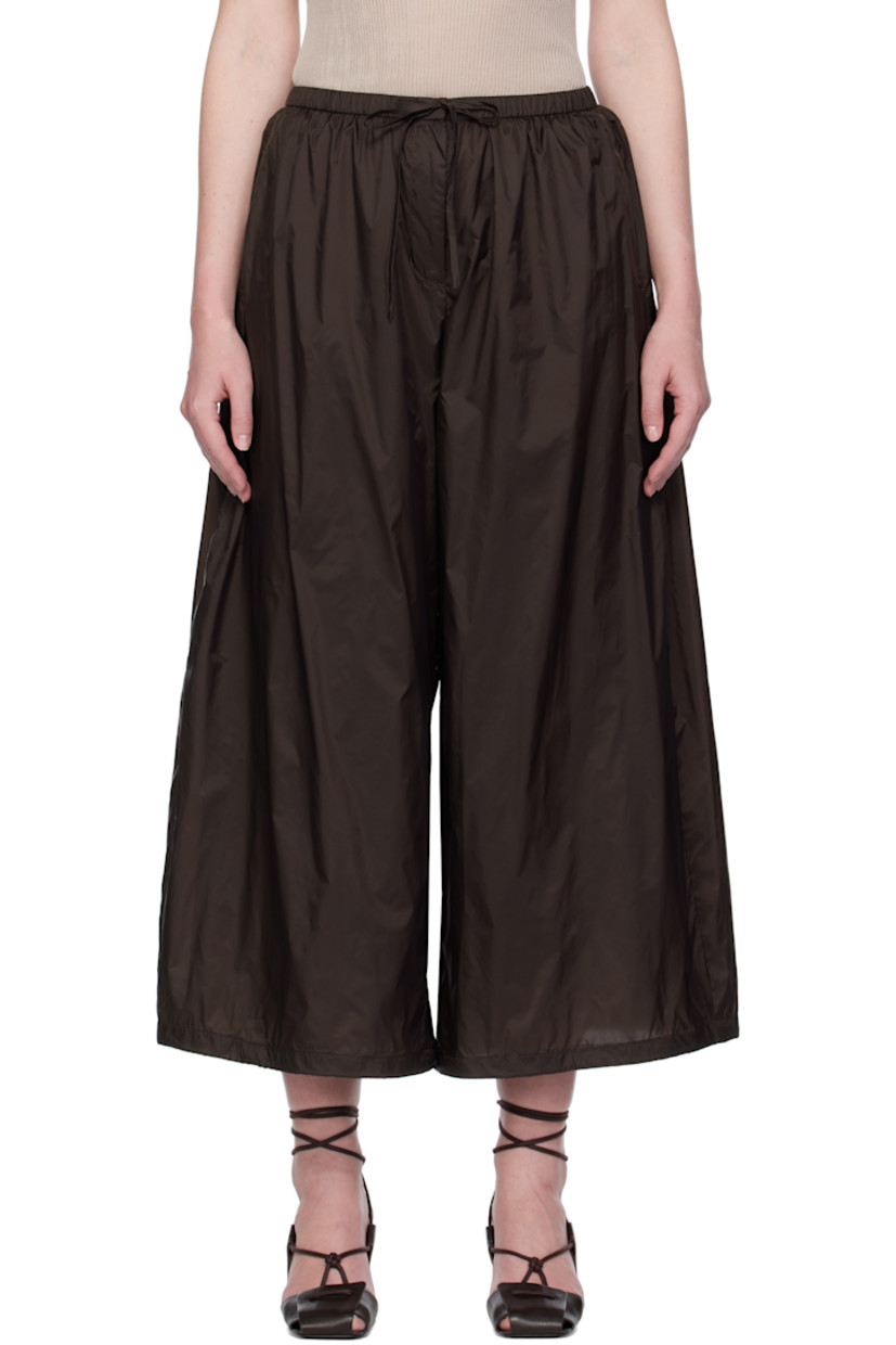 Lightweight nylon technical satin lounge pants.

· Drawstring at elasticized waistband
· Four-pocket styling
· Zip fly
· Concealed bungee-style drawstring at cuffs
· Full mesh lining

Supplier color: Dark brown