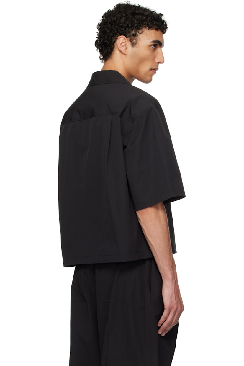 Oversized polyester- and cotton-blend poplin shirt.

· Open spread collar
· Button closure
· Patch pockets
· Cropped hem
· Twin pleats at back yoke

Supplier color: Black