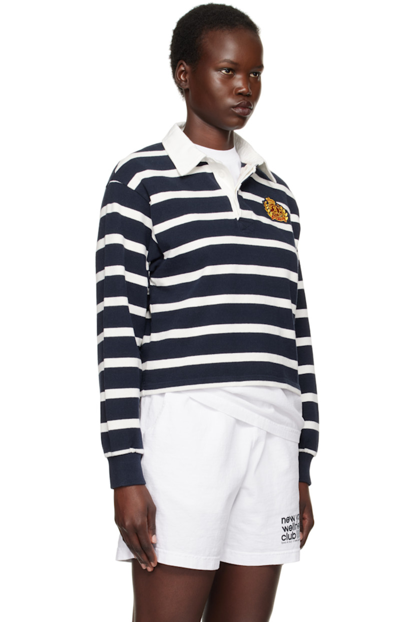 Pre-shrunk knit cotton polo. Stripes throughout. 

· Twill spread collar
· Concealed three-button placket
· Embroidered logo patch at chest 
· Rib-knit cuffs
· Mother-of-pearl hardware

Supplier color: White/Navy
