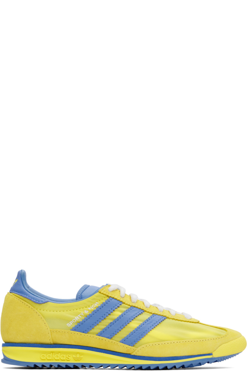 Low-top canvas and suede sneakers in yellow and blue.

· Lace-up closure
· Logo patch at padded tongue
· Padded collar
· Logo printed at outer side
· Signature serrated stripes at sides
· Logo printed at heel tab
· Logo embossed at midsole
· Treaded rubber sole

Part of the Sporty & Rich x adidas Originals collaboration.

Supplier color: Light yellow/Real blue