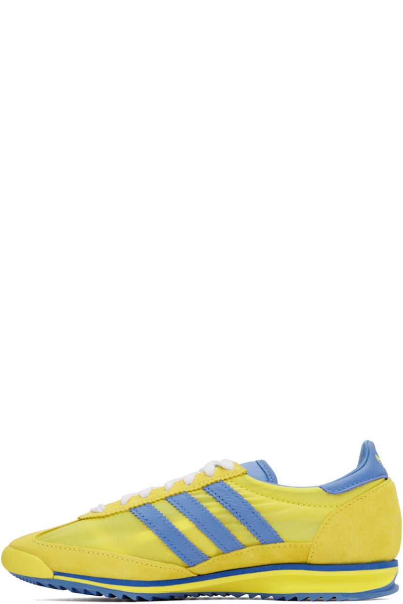 Low-top canvas and suede sneakers in yellow and blue.

· Lace-up closure
· Logo patch at padded tongue
· Padded collar
· Logo printed at outer side
· Signature serrated stripes at sides
· Logo printed at heel tab
· Logo embossed at midsole
· Treaded rubber sole

Part of the Sporty & Rich x adidas Originals collaboration.

Supplier color: Light yellow/Real blue