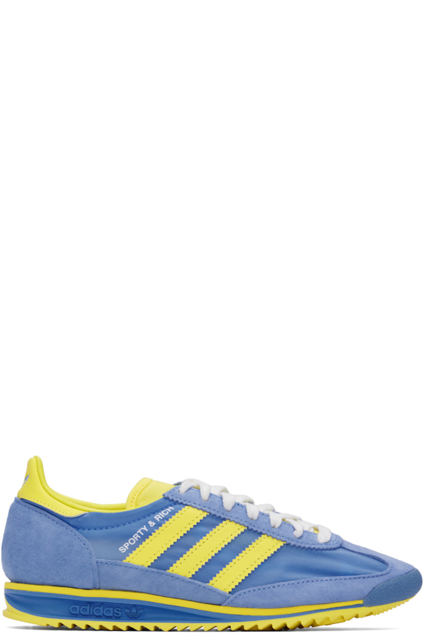 Low-top canvas and suede sneakers in yellow and blue.

· Lace-up closure
· Logo patch at padded tongue
· Padded collar
· Logo printed at outer side
· Signature serrated stripes at sides
· Logo printed at heel tab
· Logo embossed at midsole
· Treaded rubber sole

Part of the Sporty & Rich x adidas Originals collaboration.

Supplier color: Real blue/Light yellow