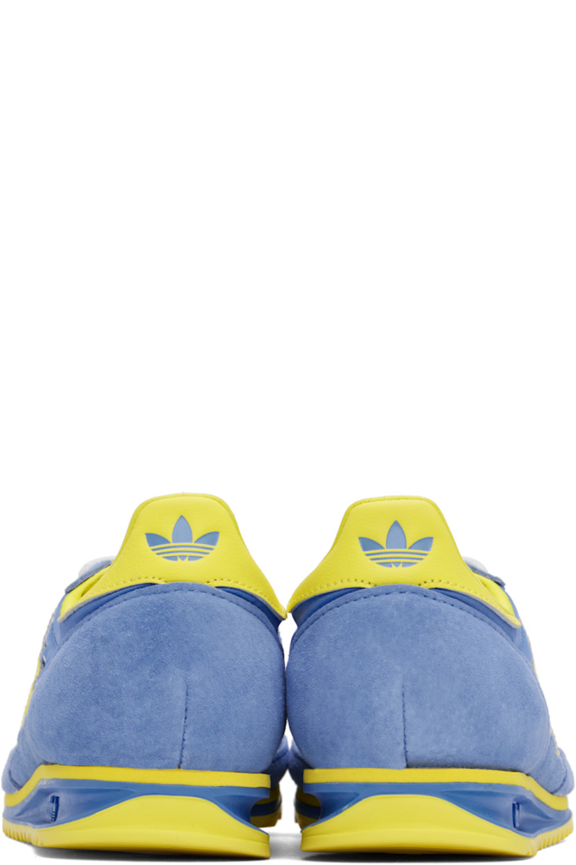Low-top canvas and suede sneakers in yellow and blue.

· Lace-up closure
· Logo patch at padded tongue
· Padded collar
· Logo printed at outer side
· Signature serrated stripes at sides
· Logo printed at heel tab
· Logo embossed at midsole
· Treaded rubber sole

Part of the Sporty & Rich x adidas Originals collaboration.

Supplier color: Real blue/Light yellow