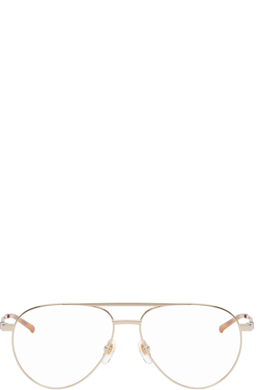 Aviator-style metal-frame optical glasses in gold tone. 

· Top bar
· Adjustable rubber nose pads
· Logo hardware and engraved logo at temple
· Tortoiseshell acetate temple tips
· Includes case
· Size: 56.15 145

Supplier color: Gold
