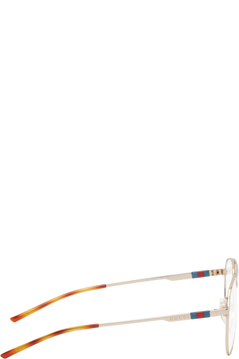 Aviator-style metal-frame optical glasses in gold tone. 

· Top bar
· Adjustable rubber nose pads
· Logo hardware and engraved logo at temple
· Tortoiseshell acetate temple tips
· Includes case
· Size: 56.15 145

Supplier color: Gold