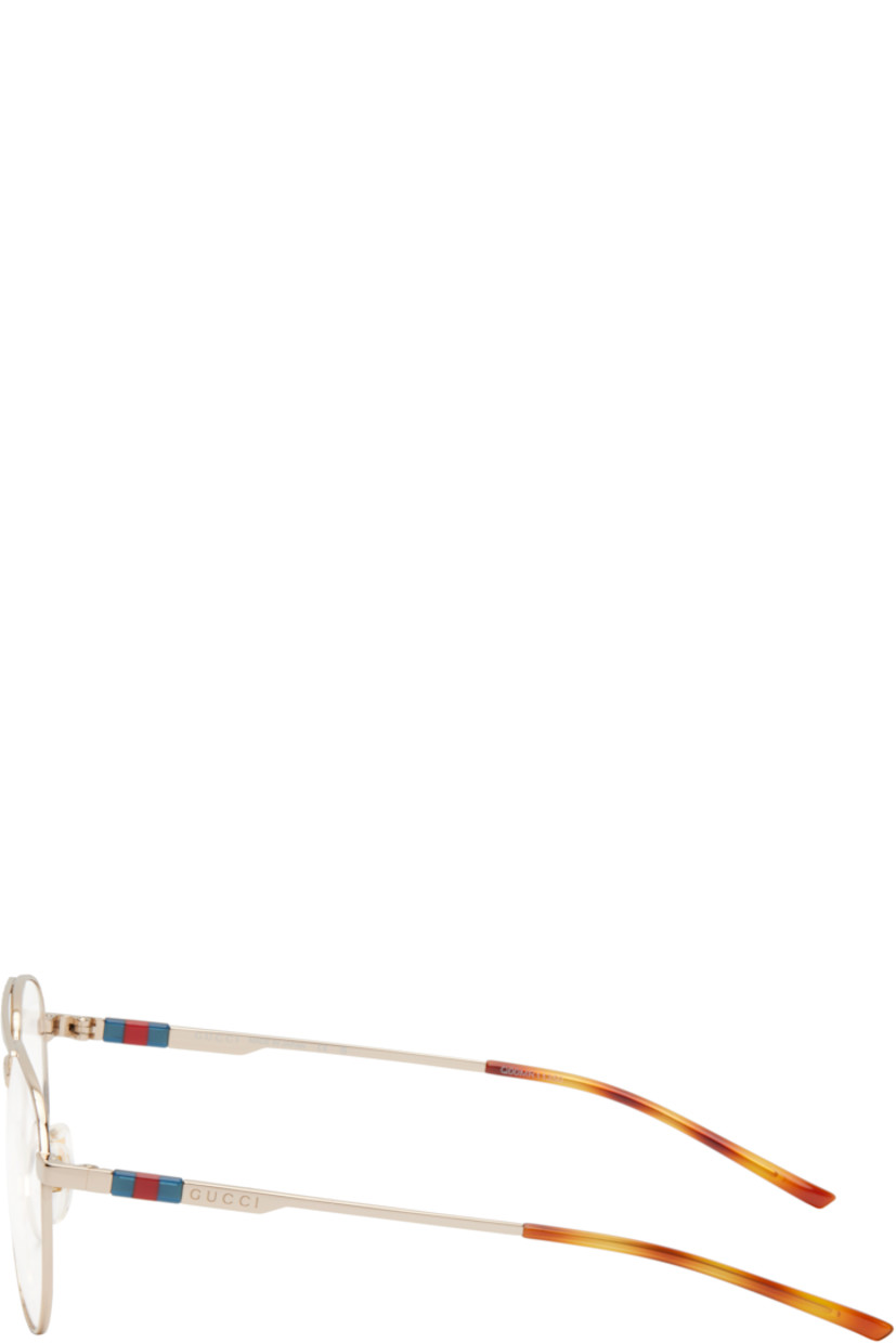 Aviator-style metal-frame optical glasses in gold tone. 

· Top bar
· Adjustable rubber nose pads
· Logo hardware and engraved logo at temple
· Tortoiseshell acetate temple tips
· Includes case
· Size: 56.15 145

Supplier color: Gold