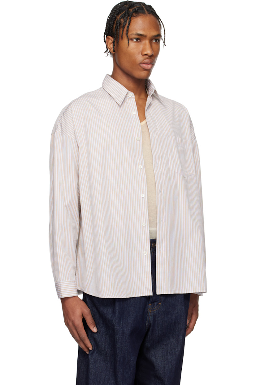 Lightweight cotton poplin shirt. Stripes throughout.

· Spread collar
· Button closure
· Patch pocket at chest
· Shirttail hem
· Dropped shoulders
· Single-button barrel cuffs
· Mother-of-pearl hardware

Supplier color: Sand