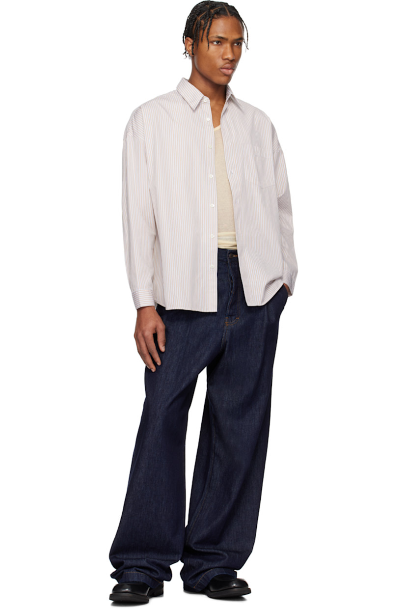 Lightweight cotton poplin shirt. Stripes throughout.

· Spread collar
· Button closure
· Patch pocket at chest
· Shirttail hem
· Dropped shoulders
· Single-button barrel cuffs
· Mother-of-pearl hardware

Supplier color: Sand