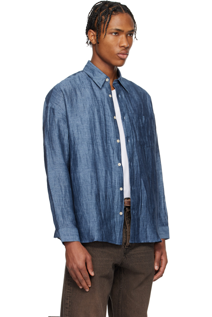 Crinkled linen-blend gauze shirt. 

· Spread collar
· Button closure
· Patch pocket at chest
· Shirttail hem
· Dropped shoulders
· Single-button barrel cuffs
· Mother-of-pearl hardware

Supplier color: Blue