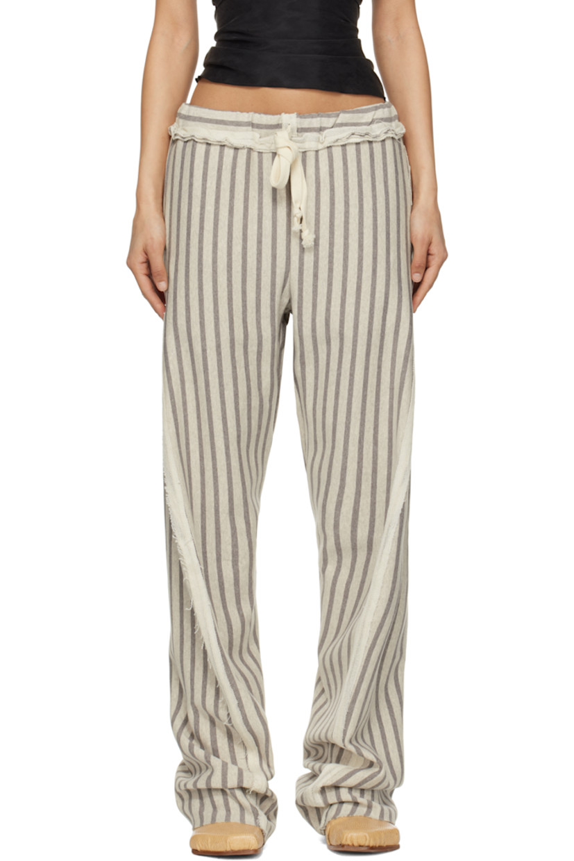French terry trousers. Stripes and inverted seams with raw edges throughout. 

· Drawstring at elasticized waistband 
· Four-pocket styling
· Twisted inseams and outseams
· Raw edge at cuffs

Supplier color: Grey/Light grey