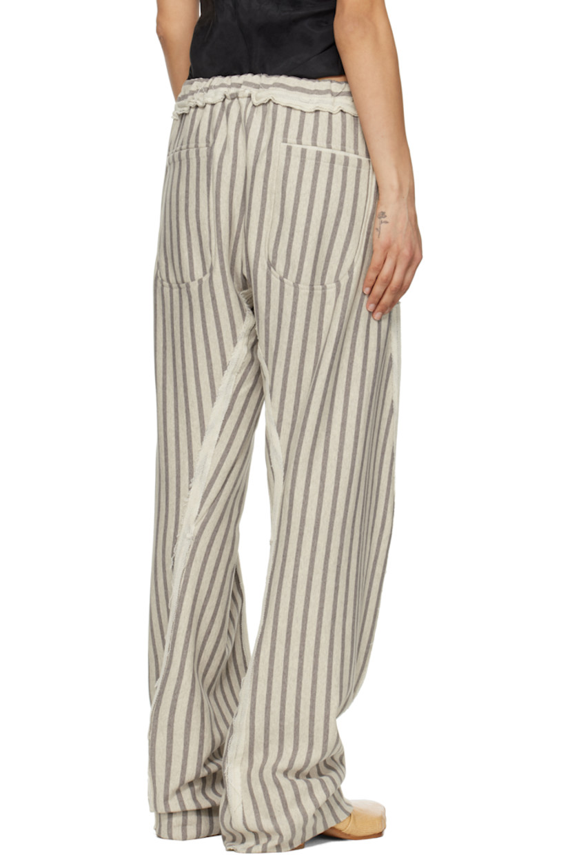 French terry trousers. Stripes and inverted seams with raw edges throughout. 

· Drawstring at elasticized waistband 
· Four-pocket styling
· Twisted inseams and outseams
· Raw edge at cuffs

Supplier color: Grey/Light grey