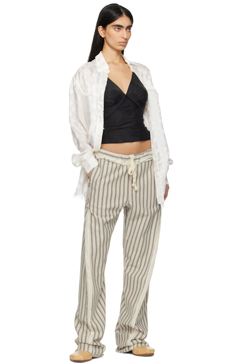 French terry trousers. Stripes and inverted seams with raw edges throughout. 

· Drawstring at elasticized waistband 
· Four-pocket styling
· Twisted inseams and outseams
· Raw edge at cuffs

Supplier color: Grey/Light grey