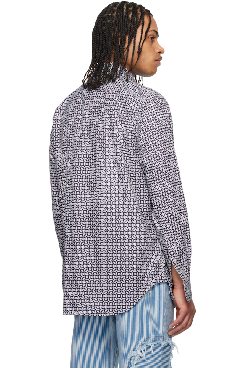 Plain-woven cotton shirt. Raw edges and graphic pattern printed throughout. 

· Patchwork construction
· Spread collar
· Button closure 
· Shirttail hem 
· Buttoned barrel cuffs
· Contrast stitching in white

Supplier color: Navy/White blue pink