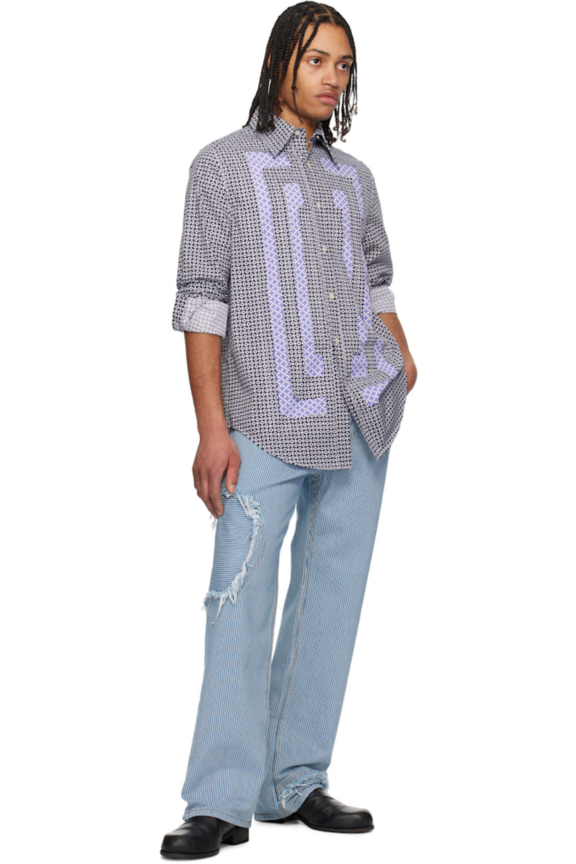 Plain-woven cotton shirt. Raw edges and graphic pattern printed throughout. 

· Patchwork construction
· Spread collar
· Button closure 
· Shirttail hem 
· Buttoned barrel cuffs
· Contrast stitching in white

Supplier color: Navy/White blue pink