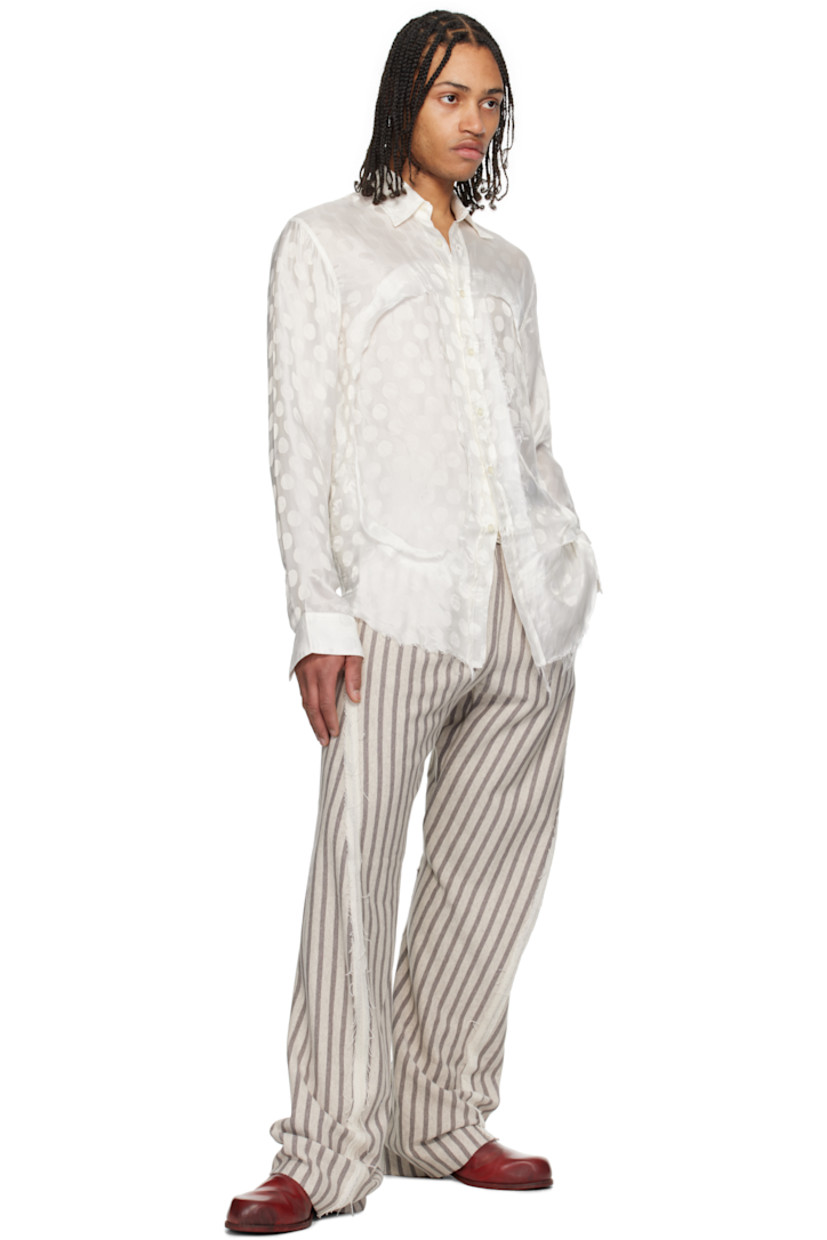 Bemberg cupro damask shirt. Jacquard polka dot pattern throughout. 

· Spread collar
· Button closure
· Inset panels with frayed edge at front
· Frayed edge at shirttail hem
· Buttoned barrel cuffs

Supplier color: White