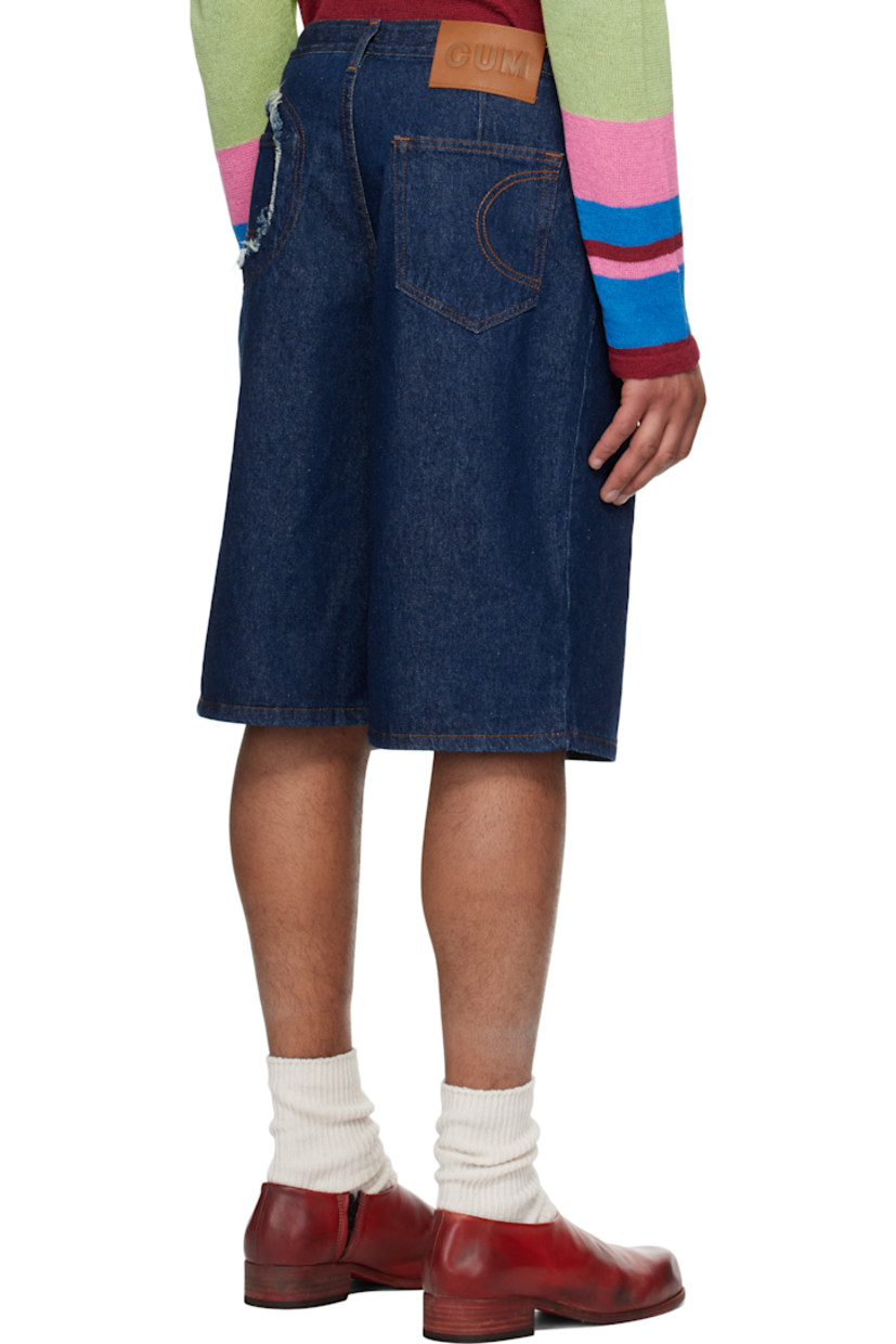 Non-stretch denim shorts. 

· Belt loops
· Five-pocket styling 
· Button-fly 
· Logo patch at back waistband
· Cutout with frayed edges at back pocket
· Graphic embroidered at back pockets
· Logo-engraved silver-tone hardware
· Contrast stitching in tan

Supplier color: Indigo wash