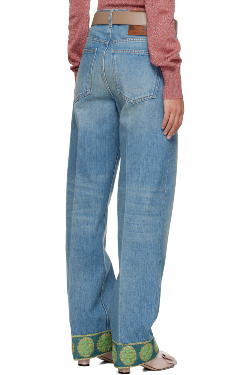 Non-stretch denim jeans. Fading and whiskering throughout.

· Belt loops
· Five-pocket styling
· Zip fly
· Creased legs
· Jacquard graphic pattern at cuffs
· Leather logo patch at back waistband
· Logo-engraved antiqued brass- and copper-tone hardware
· Contrast stitching in tan 

Supplier color: Denim