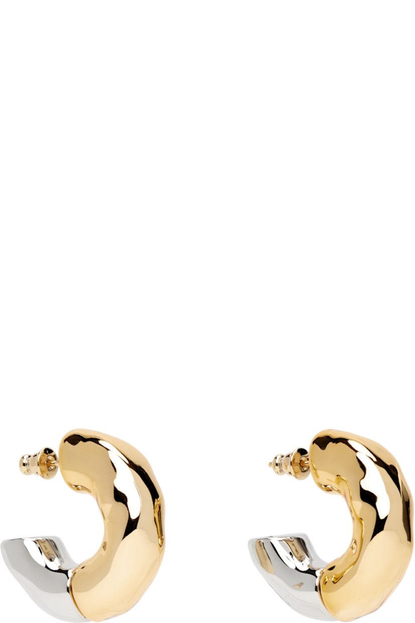 Pair of open hoop earrings in gold- and silver-tone brass.

· Hammered detailing throughout
· Post-stud fastening
· D1.25"

Supplier color: Gold/Silver