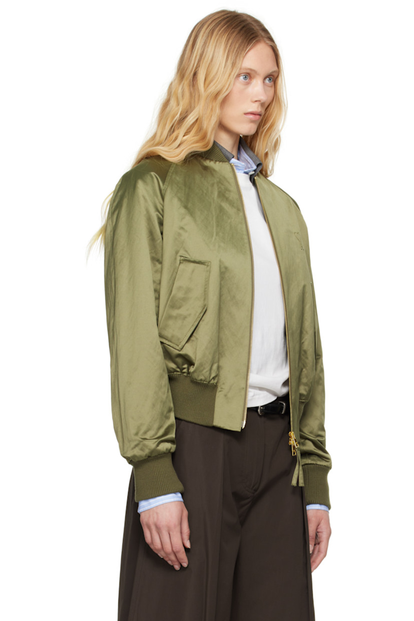 Padded cotton- and polyester-blend satin bomber jacket.

· Rib-knit stand collar, hem, and cuffs
· Two-way zip closure
· Logo embossed at chest
· Flap pockets
· Raglan sleeves
· Welt pocket at interior
· Full twill lining

Supplier color: Loden
