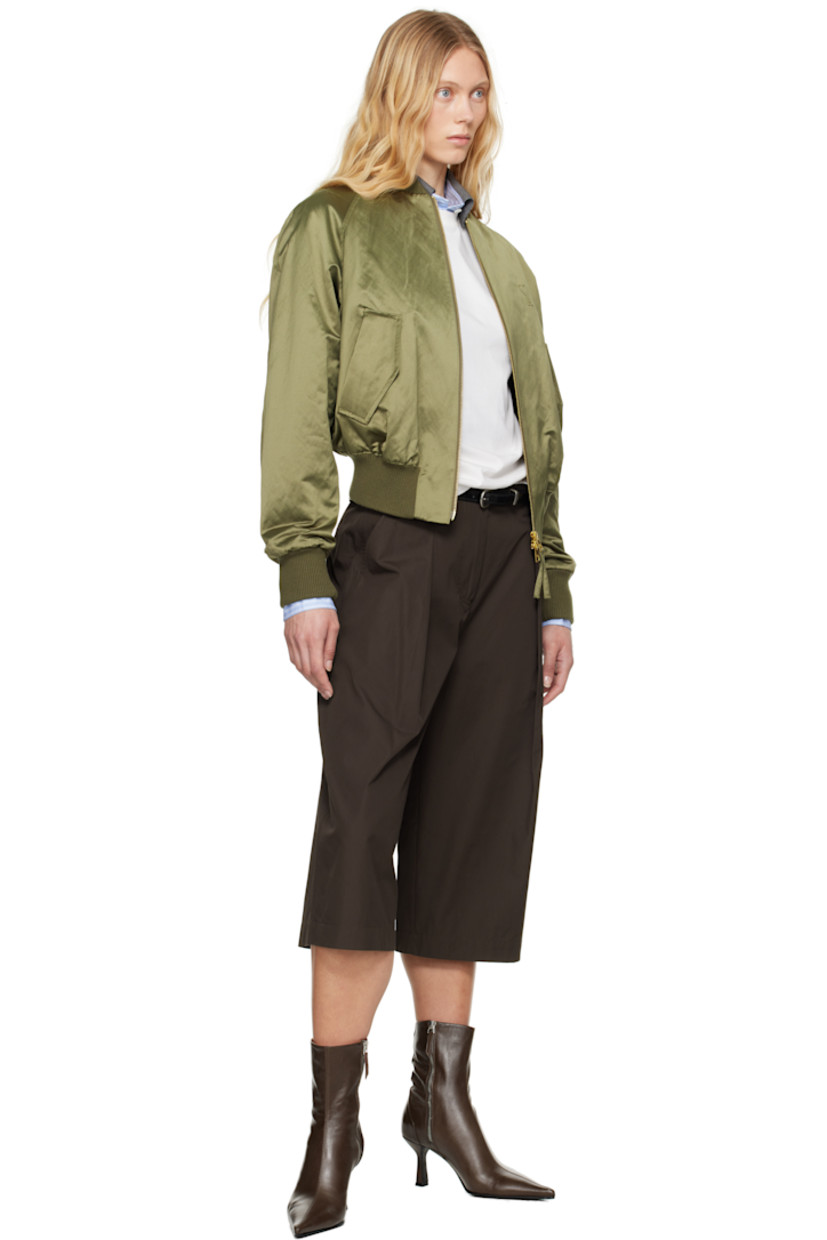 Padded cotton- and polyester-blend satin bomber jacket.

· Rib-knit stand collar, hem, and cuffs
· Two-way zip closure
· Logo embossed at chest
· Flap pockets
· Raglan sleeves
· Welt pocket at interior
· Full twill lining

Supplier color: Loden