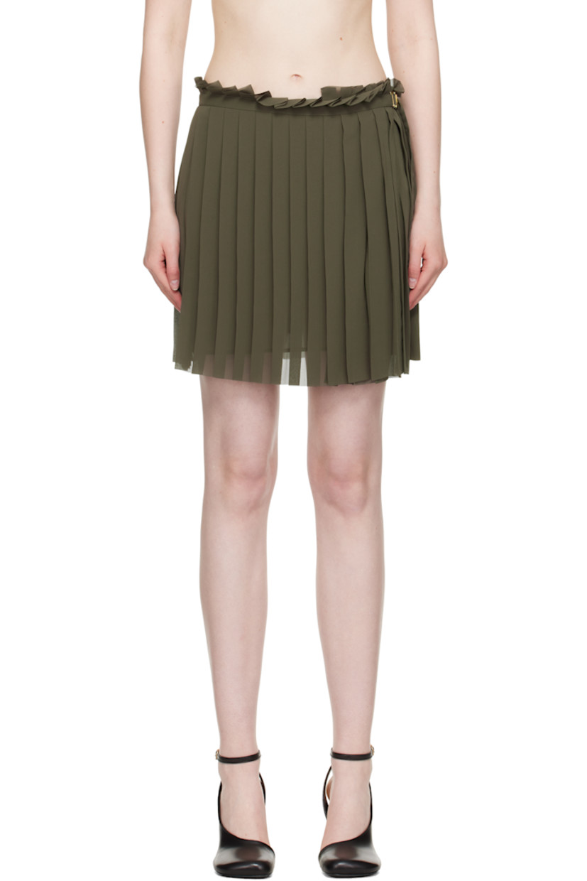Polyester crêpe miniskirt. Knife pleats throughout.

· Raw edge at elasticized waistband and hem
· Cinch strap and adjustable button fastening at side seam
· Fully lined

Supplier color: Loden