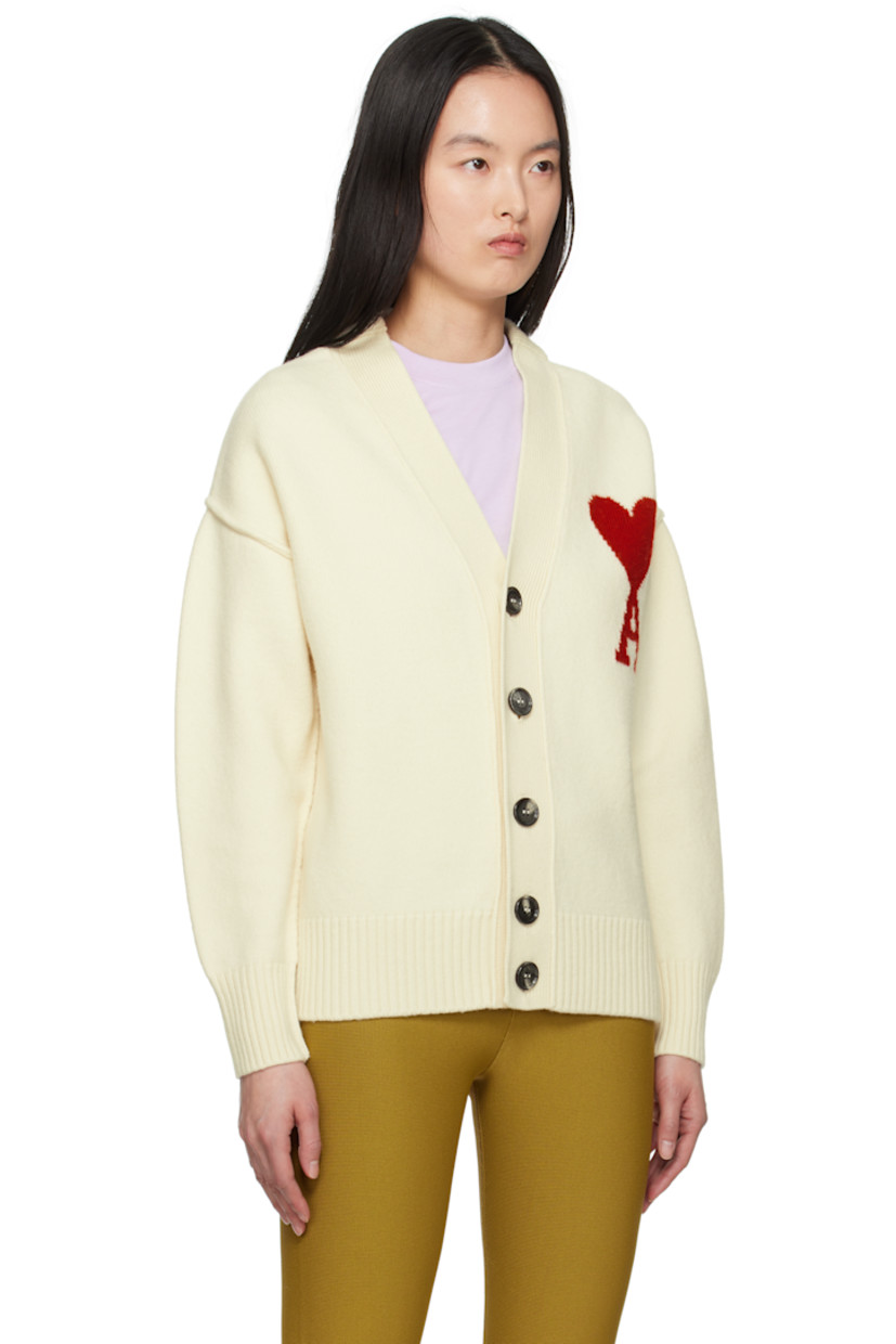 Felted knit virgin wool cardigan. Inverted seams throughout.

· Rib-knit Y-neck, hem, and cuffs
· Button closure
· Intarsia logo at chest
· Dropped shoulders

Supplier color: Off white/Red