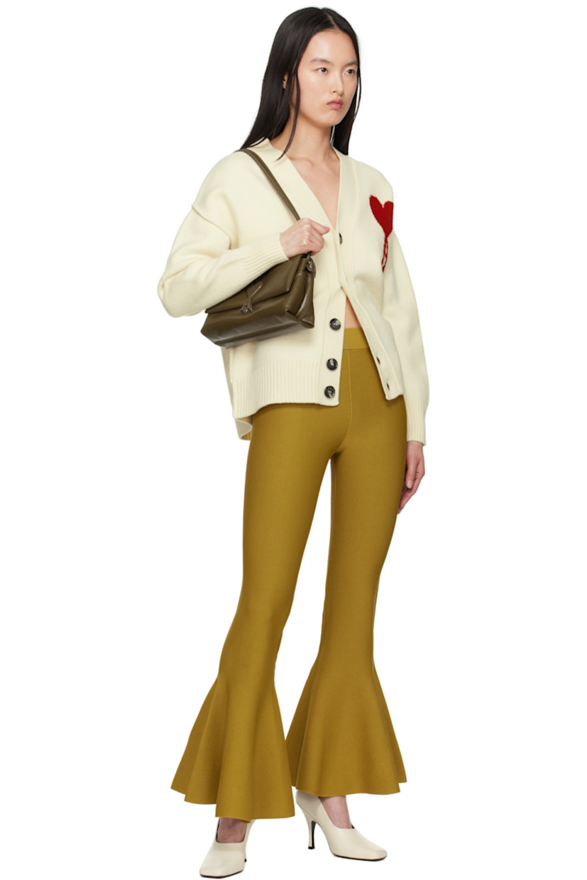Felted knit virgin wool cardigan. Inverted seams throughout.

· Rib-knit Y-neck, hem, and cuffs
· Button closure
· Intarsia logo at chest
· Dropped shoulders

Supplier color: Off white/Red