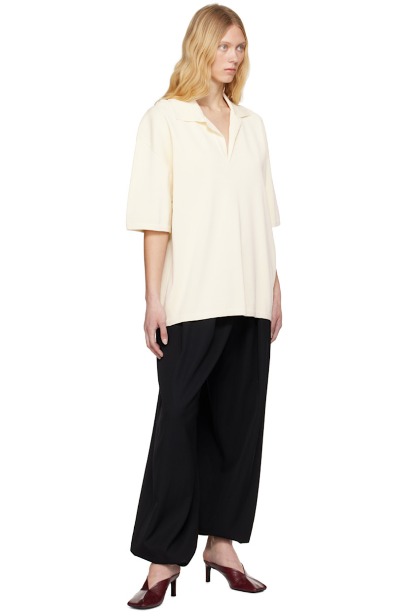 Knit viscose-blend polo.

· Rib-knit spread collar, hem, and cuffs
· Open placket
· Dropped shoulders

Supplier color: White cream
