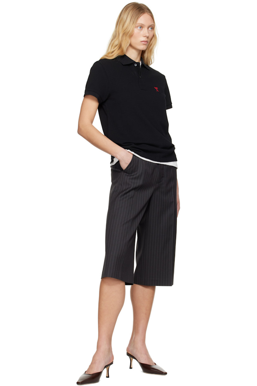 Organic cotton piqué polo.

· Rib-knit spread collar and cuffs
· Two-button placket
· Logo embroidered at chest and back collar
· Vented side seams

Supplier color: Black