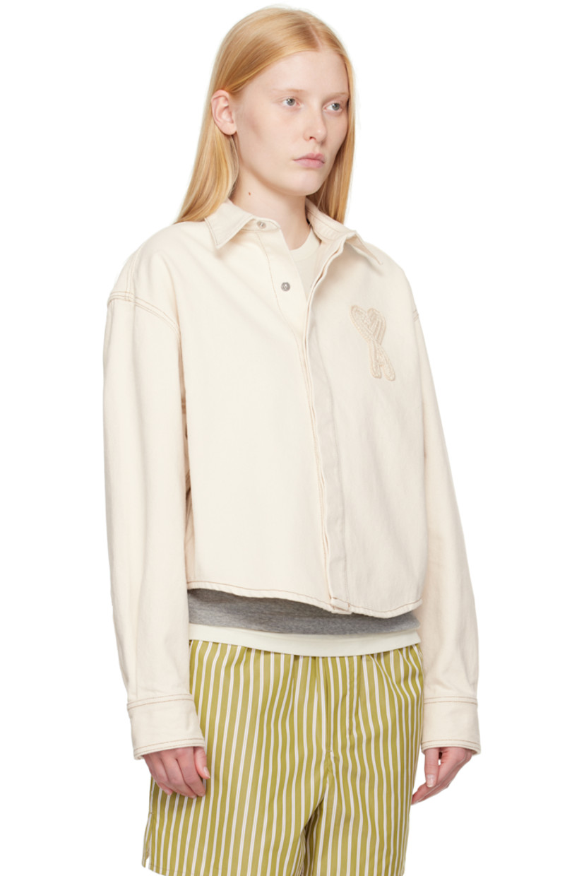 Non-stretch denim shirt.

· Spread collar
· Press-stud closure
· Logo appliqué at chest
· Cropped shirttail hem
· Press-stud barrel cuffs
· Contrast stitching in tan

Supplier color: White cream