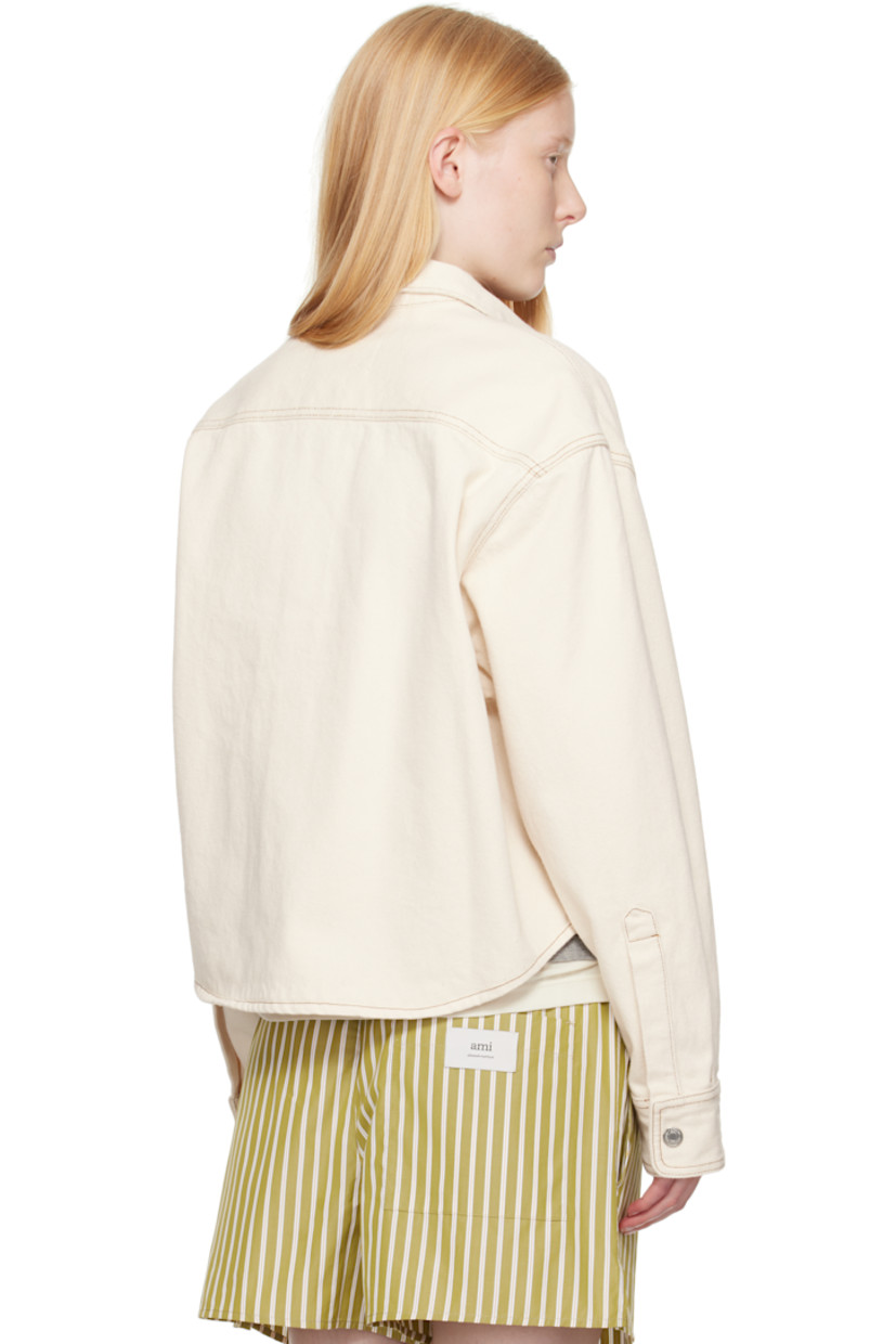 Non-stretch denim shirt.

· Spread collar
· Press-stud closure
· Logo appliqué at chest
· Cropped shirttail hem
· Press-stud barrel cuffs
· Contrast stitching in tan

Supplier color: White cream
