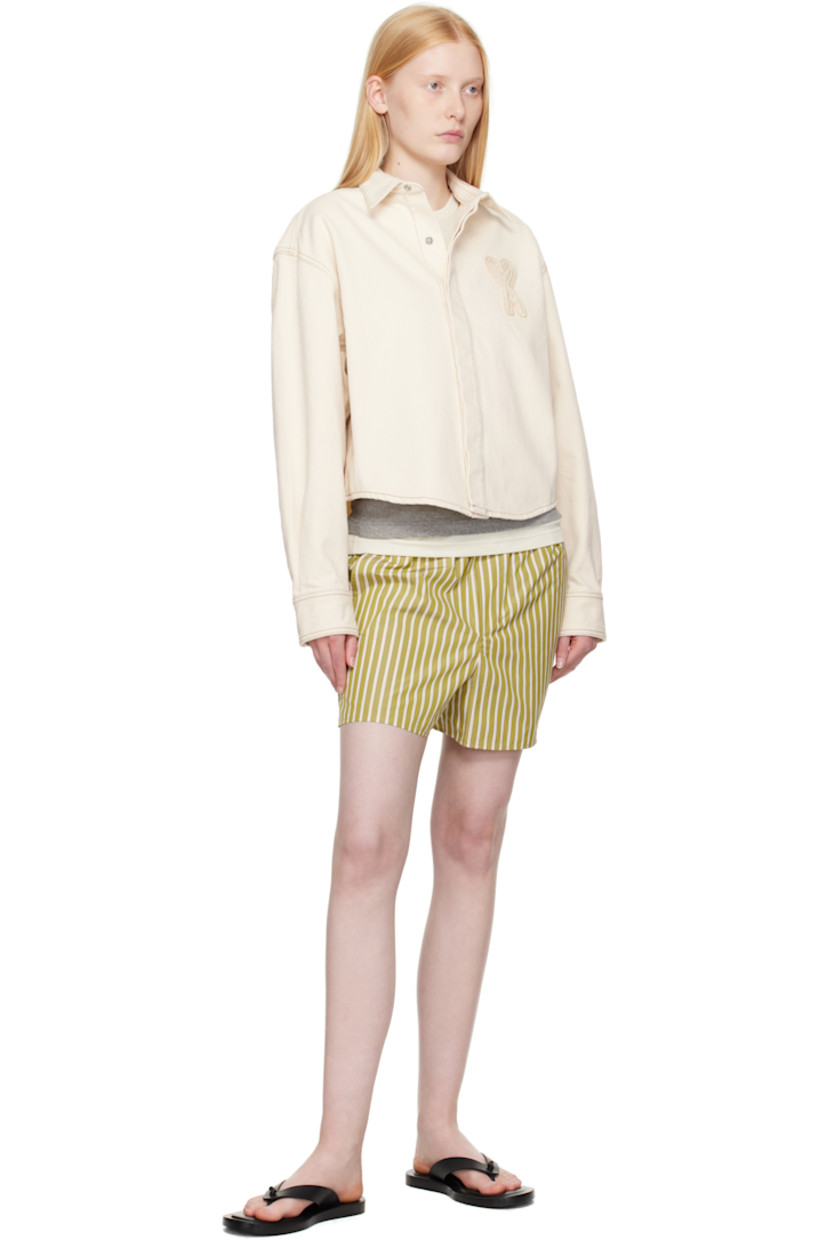 Non-stretch denim shirt.

· Spread collar
· Press-stud closure
· Logo appliqué at chest
· Cropped shirttail hem
· Press-stud barrel cuffs
· Contrast stitching in tan

Supplier color: White cream