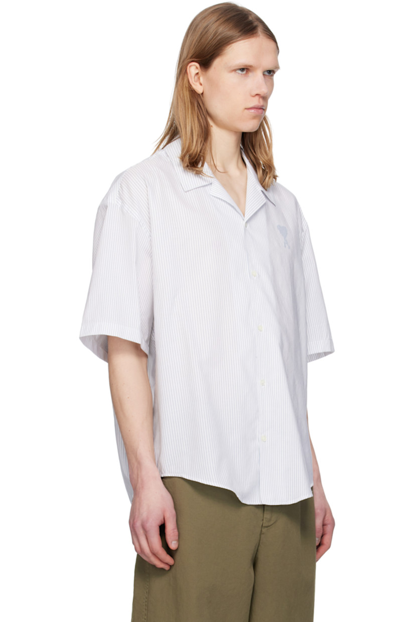 Boxy-fit cotton poplin shirt. Stripes throughout.

· Spread collar
· Button closure
· Logo printed at chest 
· Shirttail hem
· Dropped shoulders
· Mother-of-pearl hardware

Supplier color: White/Blue note