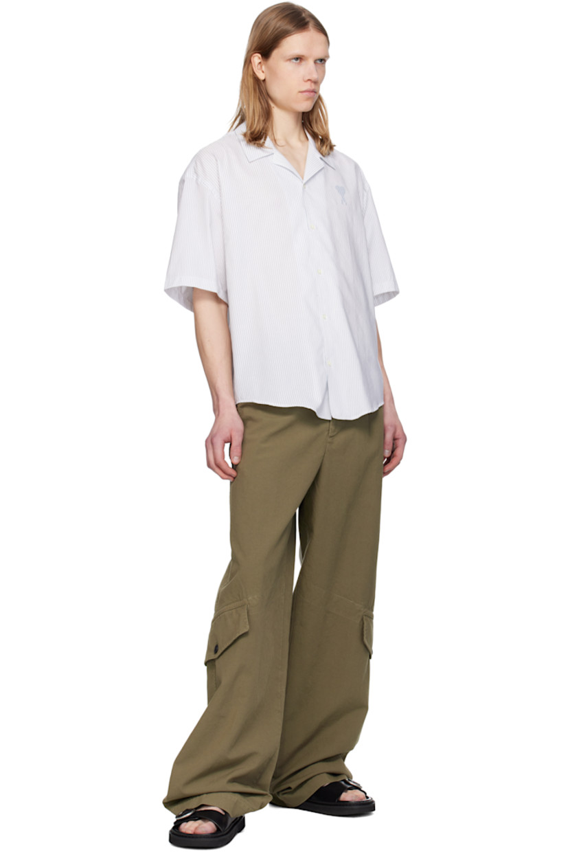 Boxy-fit cotton poplin shirt. Stripes throughout.

· Spread collar
· Button closure
· Logo printed at chest 
· Shirttail hem
· Dropped shoulders
· Mother-of-pearl hardware

Supplier color: White/Blue note