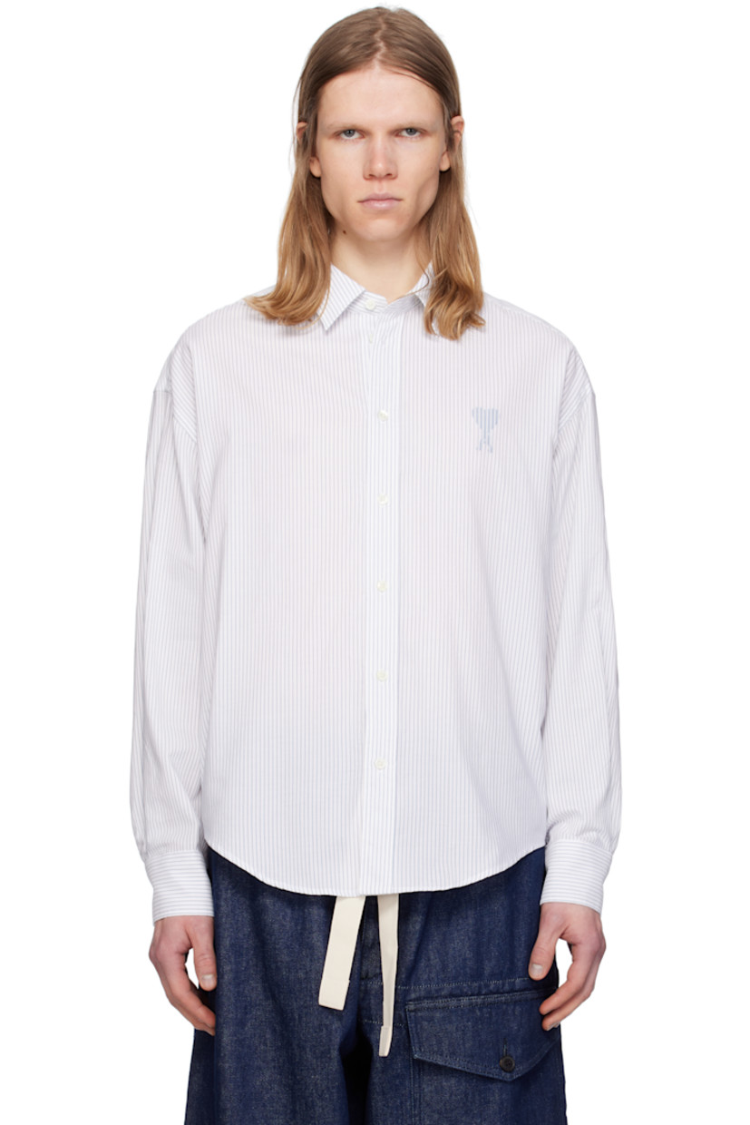 Boxy-fit cotton poplin shirt. Stripes throughout.

· Spread collar
· Button closure
· Logo printed at chest 
· Shirttail hem
· Dropped shoulders
· Pleated single-button barrel cuffs
· Mother-of-pearl hardware

Supplier color: White/Blue note