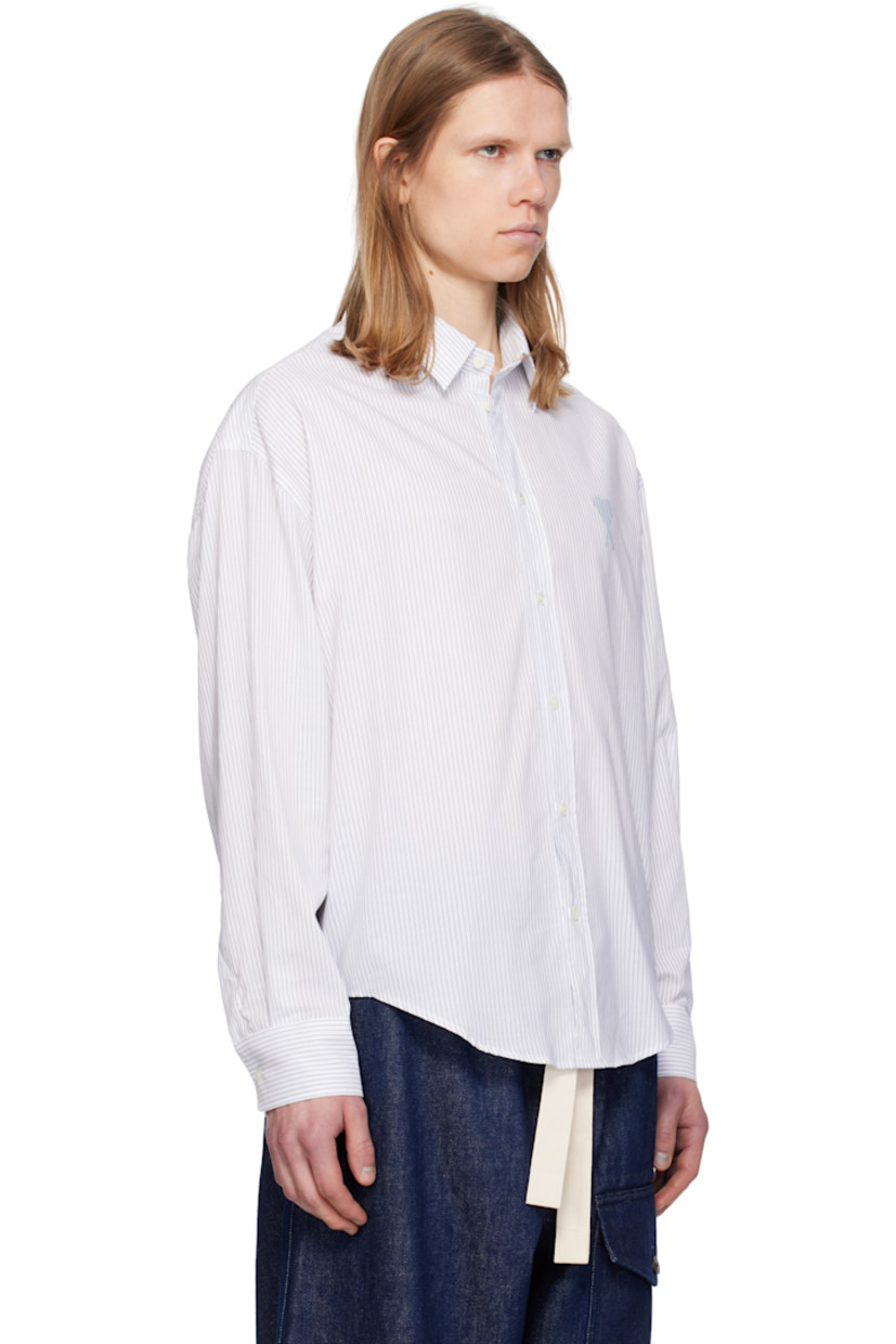 Boxy-fit cotton poplin shirt. Stripes throughout.

· Spread collar
· Button closure
· Logo printed at chest 
· Shirttail hem
· Dropped shoulders
· Pleated single-button barrel cuffs
· Mother-of-pearl hardware

Supplier color: White/Blue note