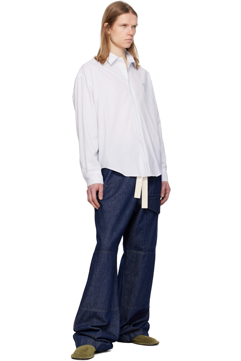 Boxy-fit cotton poplin shirt. Stripes throughout.

· Spread collar
· Button closure
· Logo printed at chest 
· Shirttail hem
· Dropped shoulders
· Pleated single-button barrel cuffs
· Mother-of-pearl hardware

Supplier color: White/Blue note