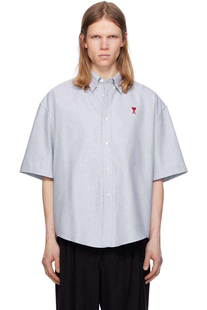 Boxy-fit cotton oxford cloth shirt.

· Button-down spread collar
· Button closure
· Logo embroidered at chest
· Shirttail hem
· Dropped shoulders
· Rolled cuffs
· Mother-of-pearl hardware

Supplier color: Blue note