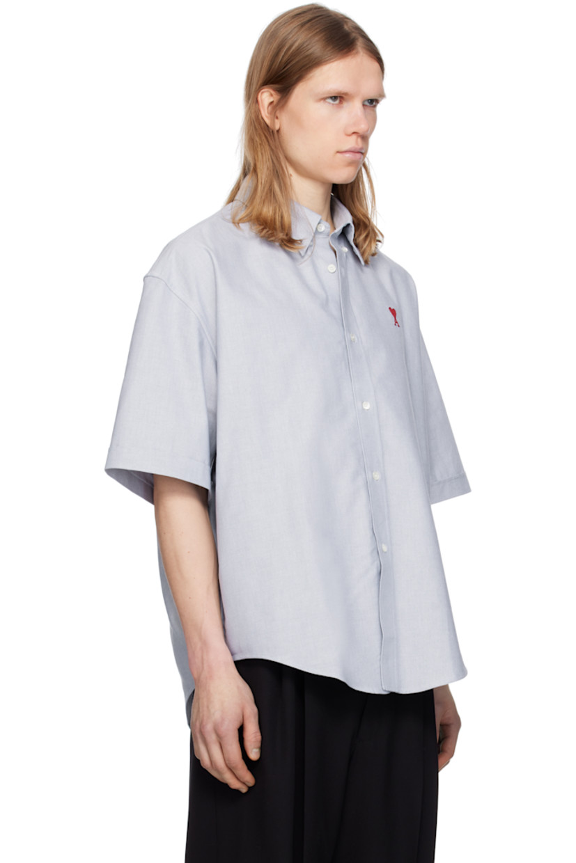 Boxy-fit cotton oxford cloth shirt.

· Button-down spread collar
· Button closure
· Logo embroidered at chest
· Shirttail hem
· Dropped shoulders
· Rolled cuffs
· Mother-of-pearl hardware

Supplier color: Blue note