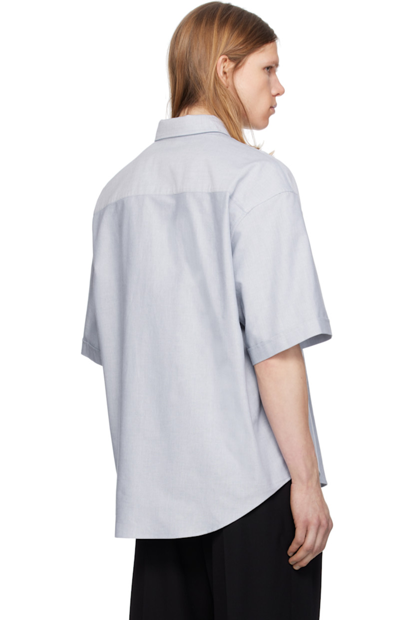 Boxy-fit cotton oxford cloth shirt.

· Button-down spread collar
· Button closure
· Logo embroidered at chest
· Shirttail hem
· Dropped shoulders
· Rolled cuffs
· Mother-of-pearl hardware

Supplier color: Blue note