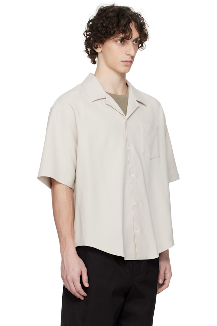 Cotton gabardine shirt.

· Open-spread collar
· Button closure
· Logo embroidered at patch pocket
· Shirttail hem
· Mother-of-pearl hardware

Supplier color: Mastic